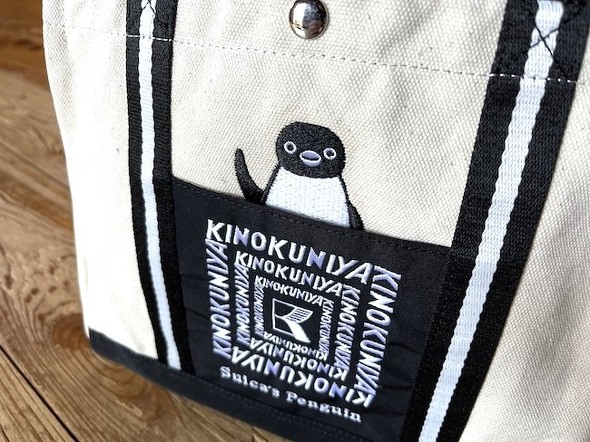 紀ノ国屋のロゴと、ペンギンが刺しゅうされている