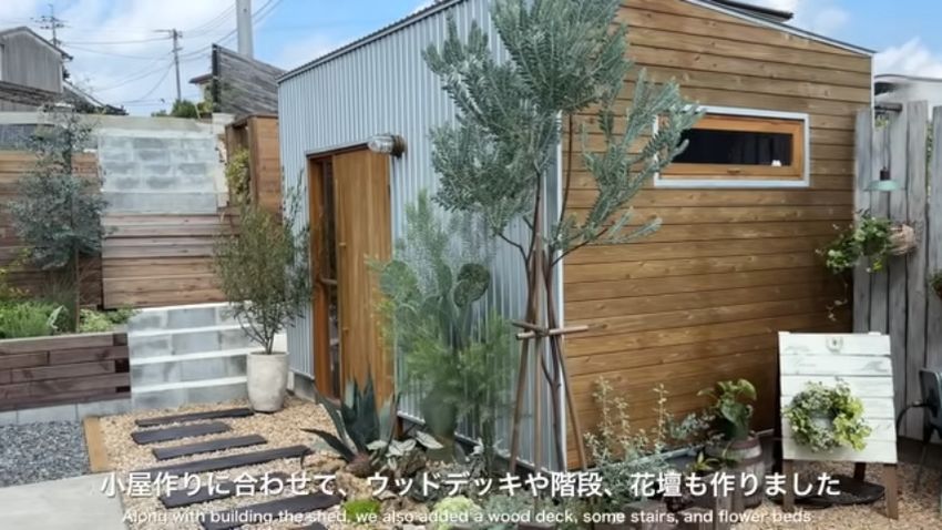 小屋の周囲に増設したウッドデッキや花壇、階段