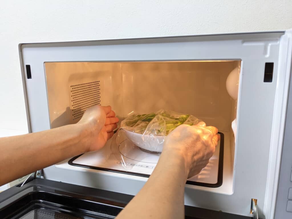 電子レンジにラップをつけた食品を入れる画像
