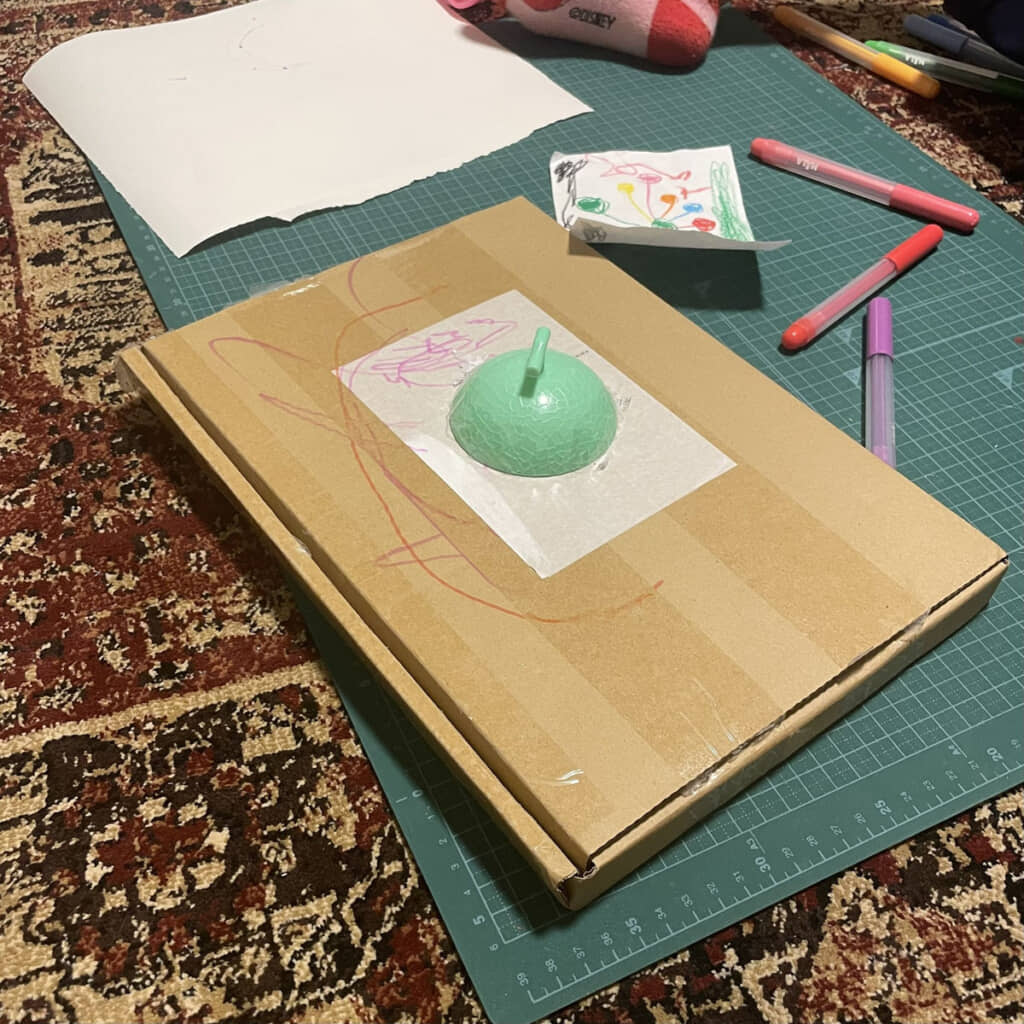 薄い箱にメロンの上半分。そういえばこんなデザインのガジェットあるよな……