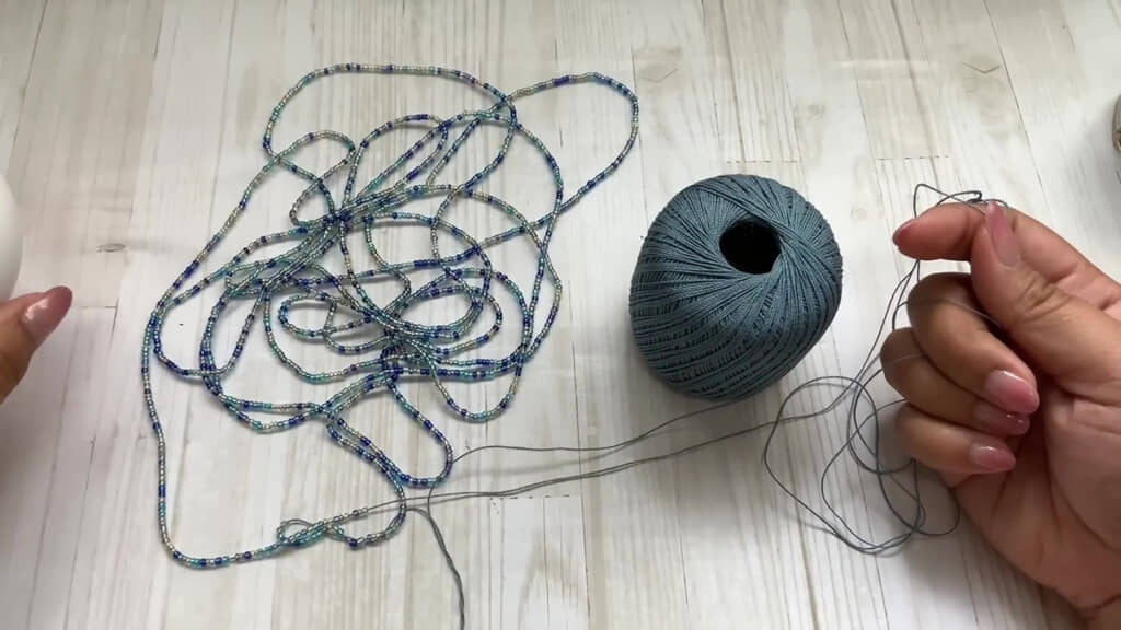 ビーズがま口作り・糸に通されたブルーとゴールドのビーズ