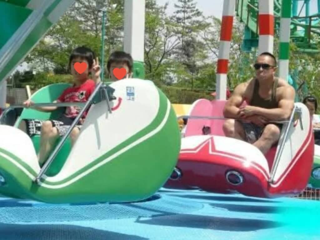 遊園地のアトラクションを楽しむ息子さんと、ボディーガードに徹するコバさん