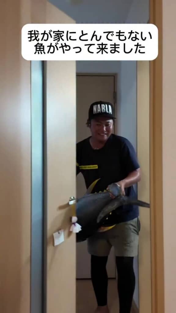 満面の笑顔で大きな物体を運び込むパパ