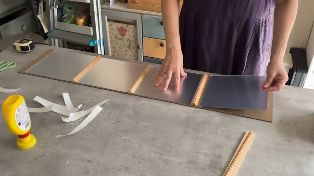 鏡をボードに接着。位置の確認のためモールディングを仮置きしている