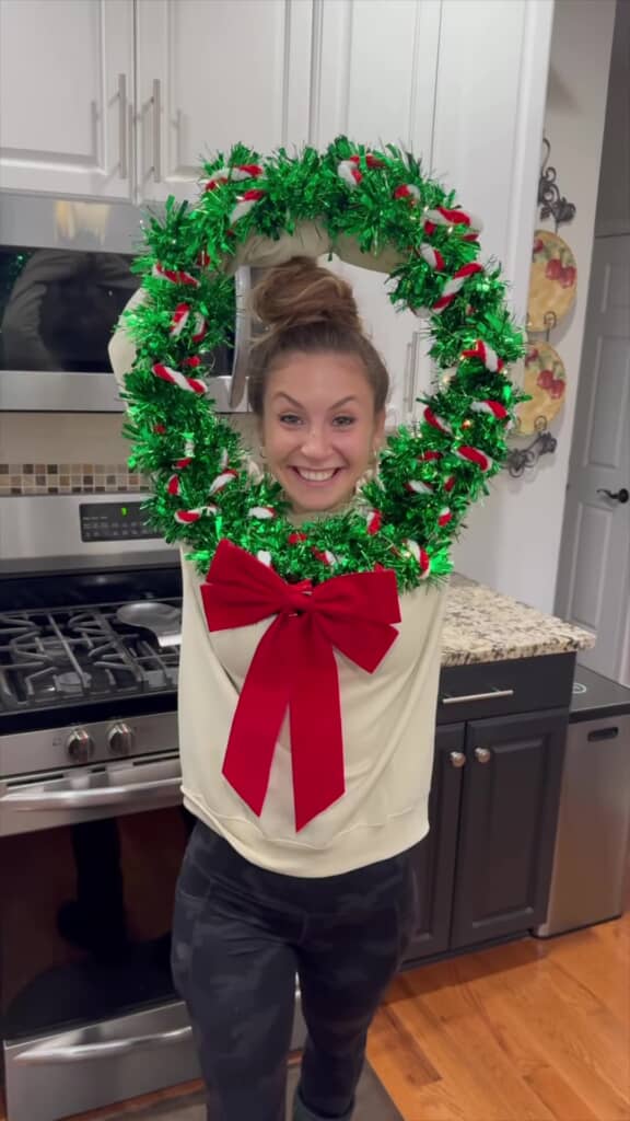両腕を丸くしたポーズで、美しいクリスマスリースが完成した状態