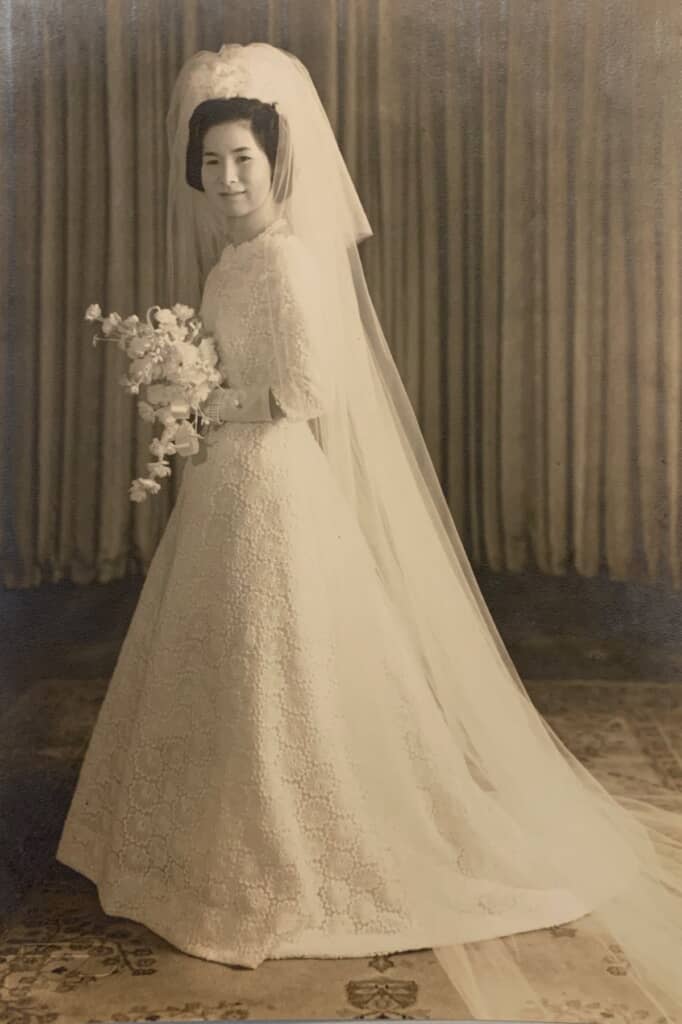 レース生地が美しい、上品なウエディングドレスを身に着けた母の花嫁姿