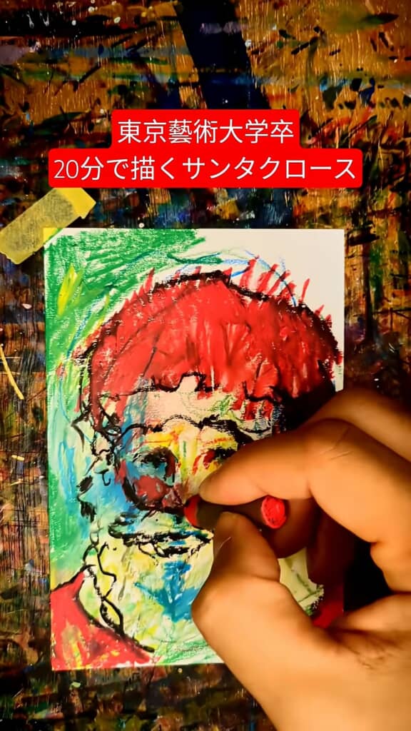 赤い帽子を塗るサンタクロースの絵を手元で描いているところ