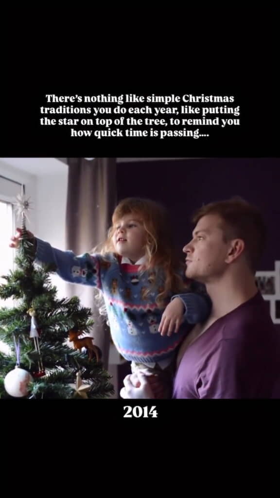 パパに抱き上げられた幼い娘が星を飾る