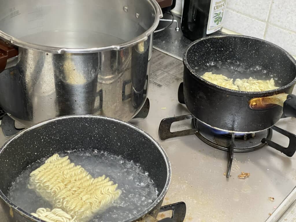 鍋でインスタント麺を同時にゆでている様子
