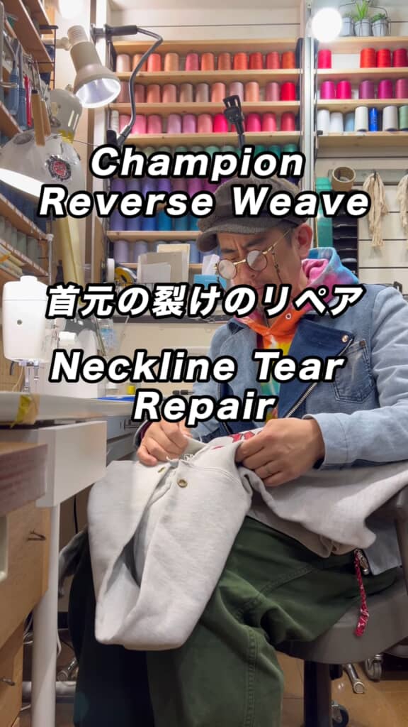 作業場でスエットの首元を手縫い修理する職人