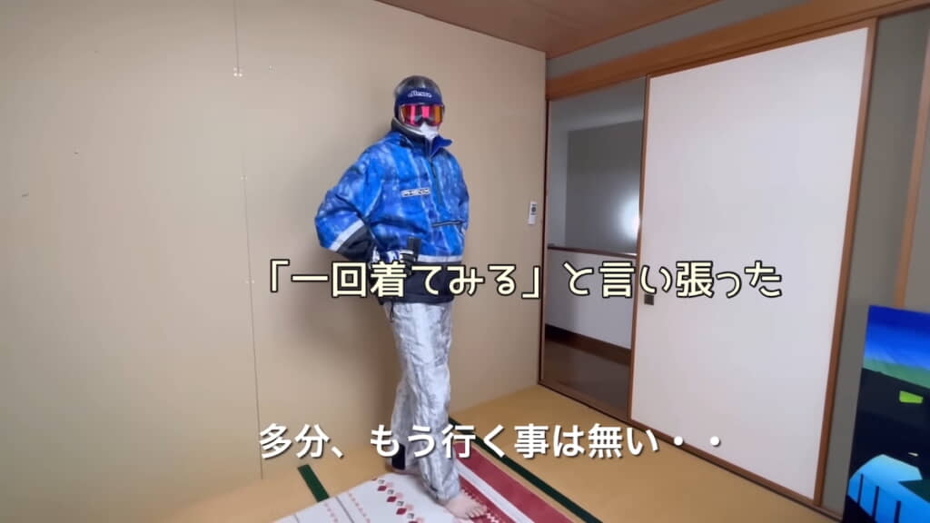 スキーウェア姿でポーズをとる夫