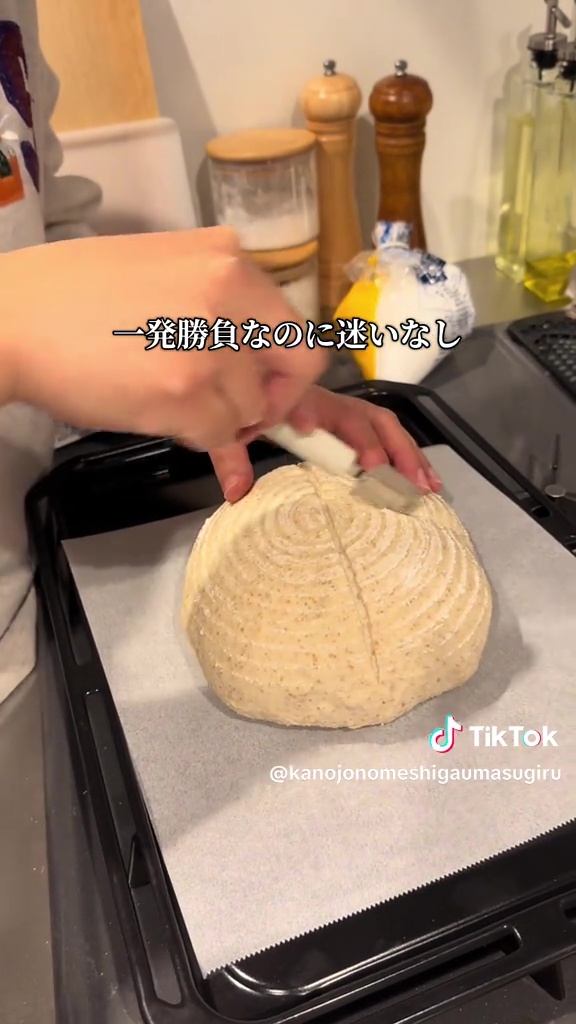 大きなパン生地にナイフを入れる