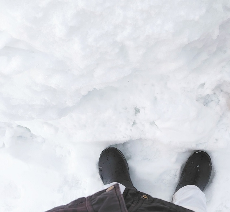 雪が積もった地面に立っている投稿者の足元