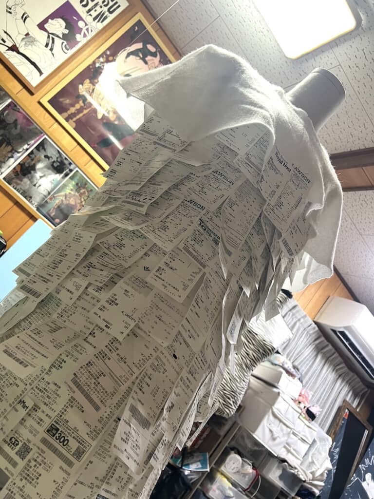 大量のレシートでできた“蓑”