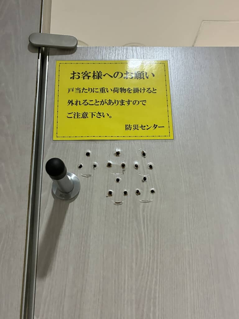 戸当たりに重い荷物を引っ掛けないよう伝える客への案内