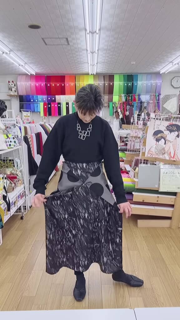 リバーシブルラップスカートを反対向きにはいた女性