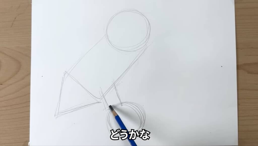 白い紙に丸や四角の図形でフクロウのあたりを取る様子