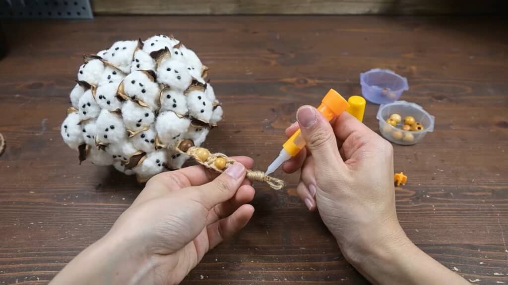 最後にヒモと飾りを取り付けて……