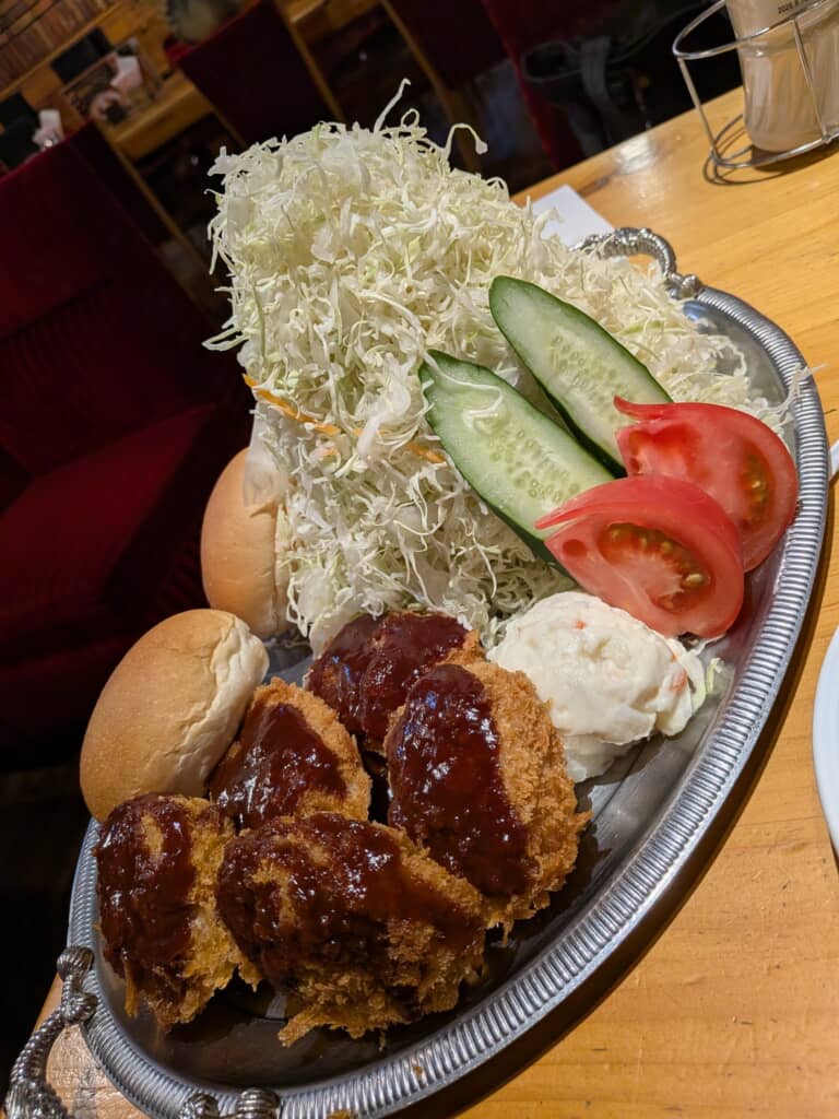コメダ珈琲店のヒレカツ、大量のキャベツ、ポテトサラダ、パンが盛られたプレート