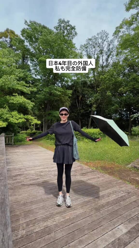紫外線対策バッチリな女性（後ろに下がって手を広げる）