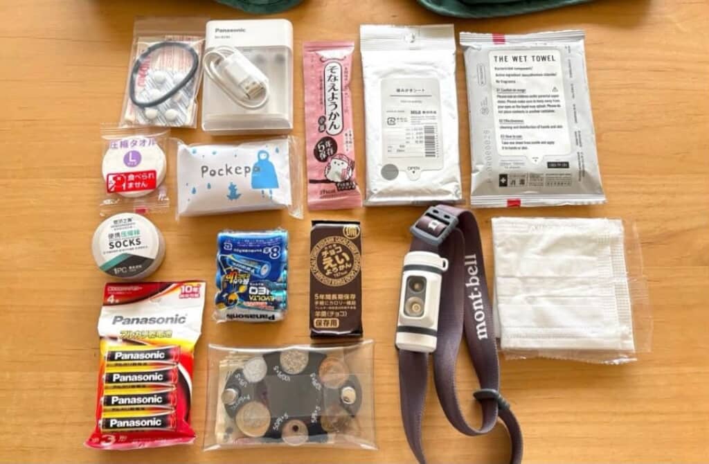 ベストの中に入れてある乾電池や衛生用品、非常食を並べた写真