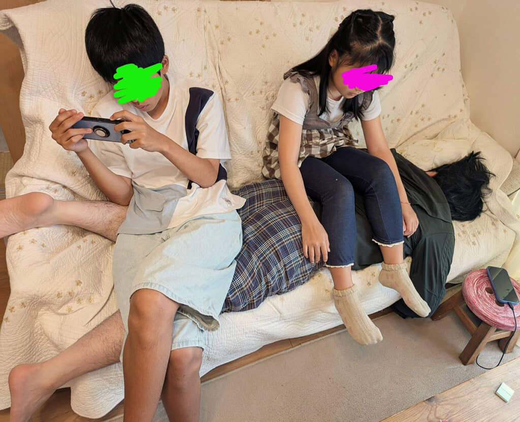 パパの上に座る子どもたち